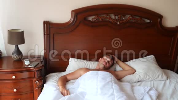 男人睡过头后醒来从床上跳起来4k慢动作视频的预览图