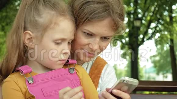 妈妈和女儿在露天使用小玩意夏季视频的预览图