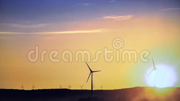 抽象的力量风车在地平线上和一个美丽的金色的日落景观产生清洁和生态能源视频的预览图