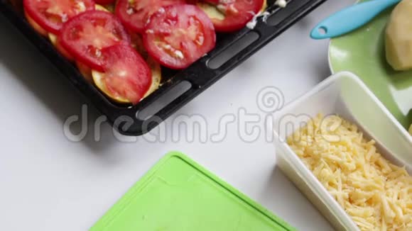 烤盘上放着一层土豆西葫芦和西红柿视频的预览图