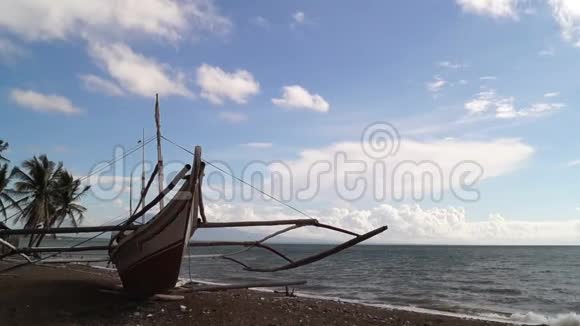 渔船停靠在晴朗的蓝天上的白色沙海岸上视频的预览图