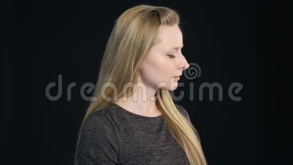 一个黑人背景的金发女孩的情感肖像视频的预览图
