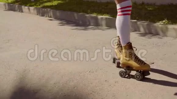 女腿在复古轮滑在道路上视频的预览图
