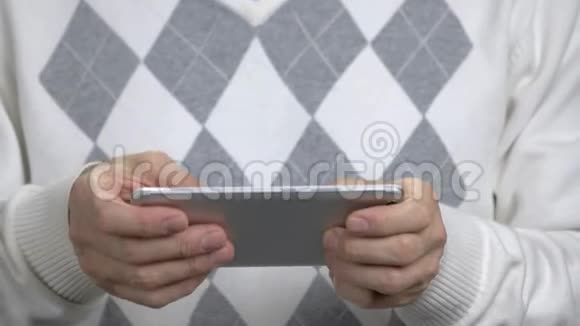 关闭男人在智能手机上玩游戏视频的预览图