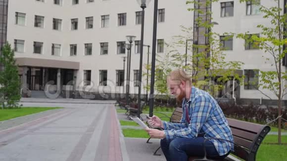 一个年轻的学生来到大学的背景下打电话拿着重要的文件视频的预览图