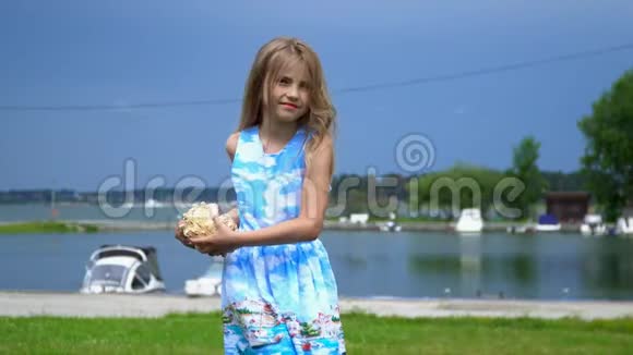 这位金发姑娘在码头上的一块草坪上转了个弯头发花白的女孩有点变了视频的预览图