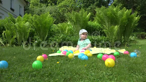 宝宝坐在格子布上享受草地上飞舞的肥皂泡4K视频的预览图
