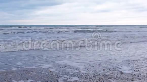 波涛汹涌海中有泡沫冬天的沙滩视频的预览图