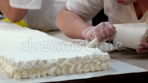 糖果师用白色奶油准备庆祝蛋糕视频的预览图