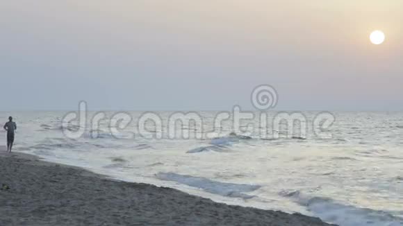 早上慢跑的女孩和男孩沿着海边的冲浪线在夏天视频的预览图