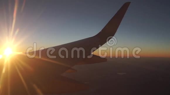 在美丽的夕阳下客机飞得很高从舷窗看视频的预览图