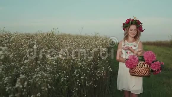 戴着花和花环的美女在田野里散步视频的预览图