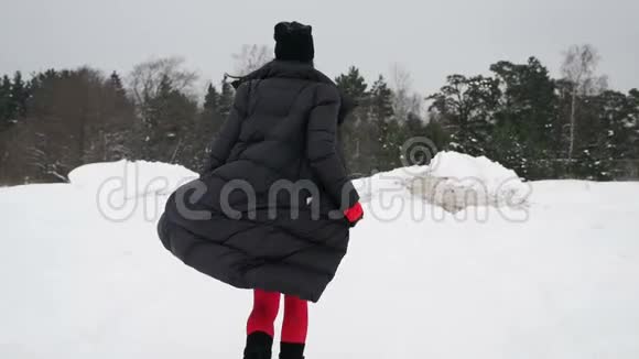 穿着红色紧身衣和靴子的女孩在冰冻的海湾上视频的预览图