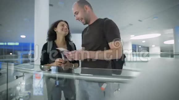 在机场等待航班的微笑情侣视频的预览图