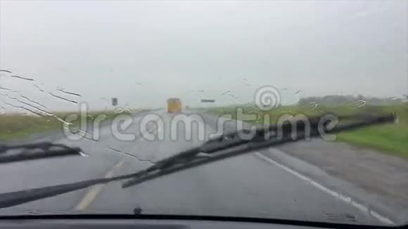汽车在雷雨中缓慢地行驶在公路上视频的预览图
