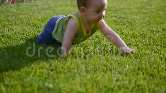 婴儿从草地上慢慢地爬行小婴儿世界慢动作视频的预览图