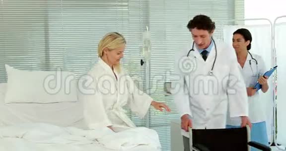 医生帮助病人坐轮椅视频的预览图