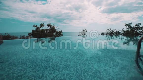 度假村山上的小型室外游泳池覆盖树木和海洋视频的预览图