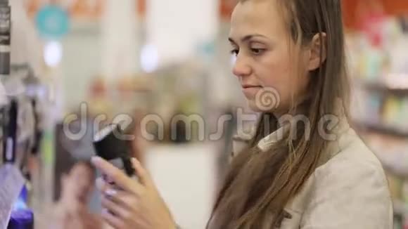 年轻的白种人女人在购物中心的美容区选择除臭剂视频的预览图