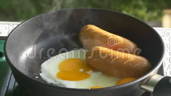 一个人在户外炸鸡蛋和香肠视频的预览图