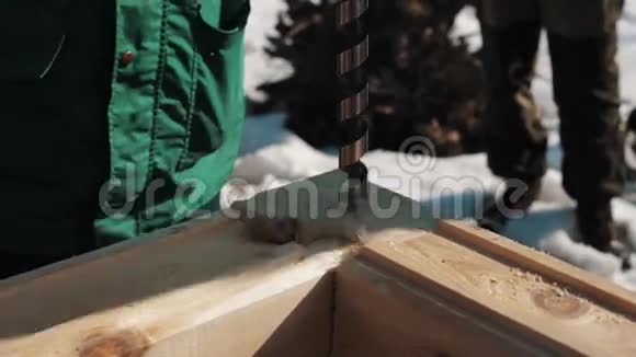 在两个木块角部连接上钻孔在外面制造锯末视频的预览图