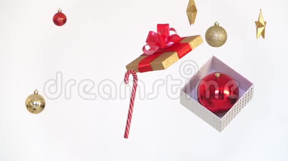 玻璃球和装饰品在打开的礼品盒周围飞舞旋转的节日漩涡圣诞循环背景视频的预览图