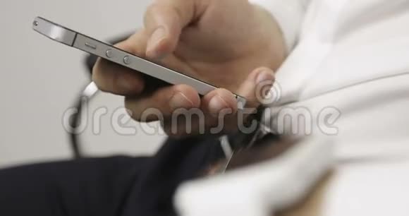 男性在手机触摸屏上做手势同时佩戴智能手表视频的预览图