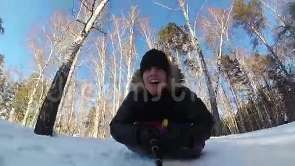 快乐的人骑着雪管在雪道上微笑慢动作冬天的雪景户外运动视频的预览图