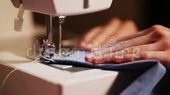 女孩在缝纫机上缝衣服蓝色和黄色的特写针视频的预览图
