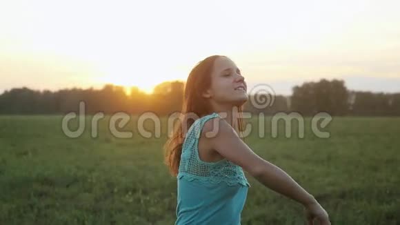 迷人的年轻女子在夕阳下在户外跳舞阳光透过太阳缓慢地照耀着1920x1080视频的预览图