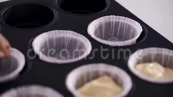 女厨师清淡的欧式菜肴上的糕点把面团做成纸杯蛋糕的形状视频的预览图