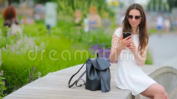 在欧洲城市拍摄自我肖像的年轻女子白人游客在公园里享受她的欧洲暑假视频的预览图