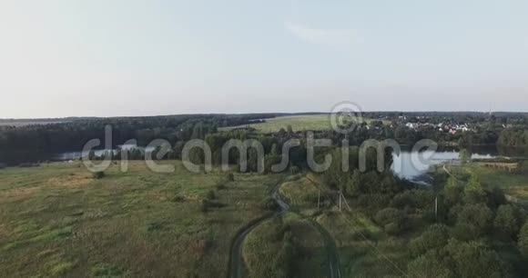 莫斯科州俄罗斯相机飞过绿色的草地飞向森林和蓝色的湖泊视频的预览图