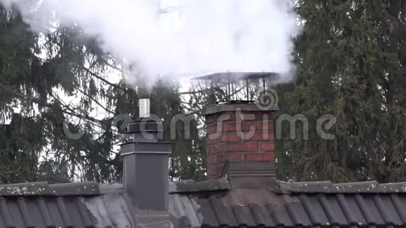 有热气闪烁的房子顶部的吸烟烟囱和烟斗视频的预览图