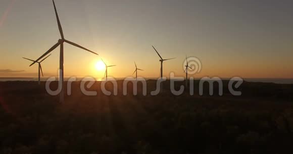 高空观风发电机在傍晚的天空上的田野风力发电机旋转叶片并提取电能视频的预览图