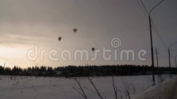 热气球飞过白雪覆盖的田野视频的预览图