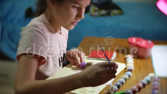 孩子画的那个女孩是一个手工艺品娃娃少女手工着色自制玩具室内生活方式视频的预览图