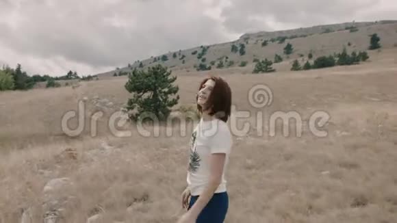 快乐的女人在田野里散步视频的预览图