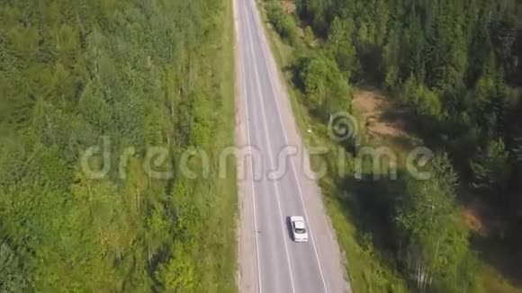 俯视风景蜿蜒的乡村道路穿过绿色农田剪辑农村公路视频的预览图