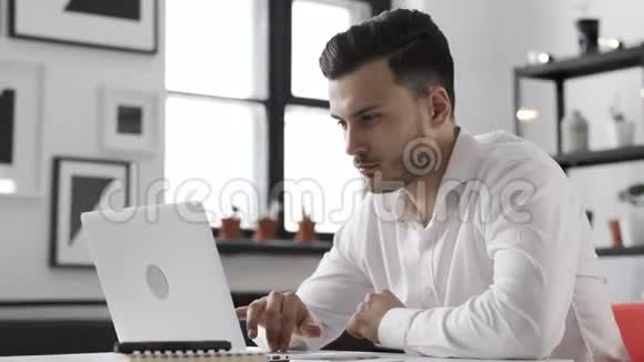 工作成功的年轻商人在笔记本电脑上办公视频的预览图