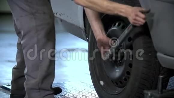 机械师拧紧汽车后部轮胎上的螺丝视频的预览图