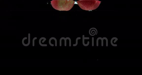 苹果苹果黑背景下进入水中的水果视频的预览图