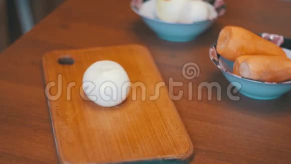 在家庭厨房的切割板上用刀将洋葱切成两部分慢动作视频的预览图