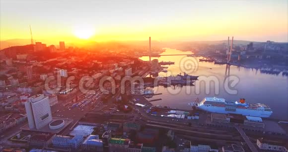 在美丽的日出时在海参崴市中心上空向后飞行俄罗斯视频的预览图
