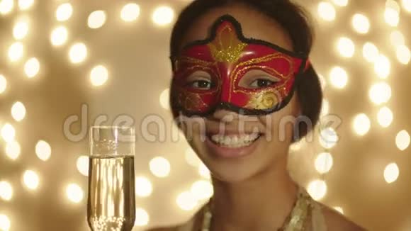 近镜头黑色女人戴着狂欢面具手中拿着香槟酒杯视频的预览图