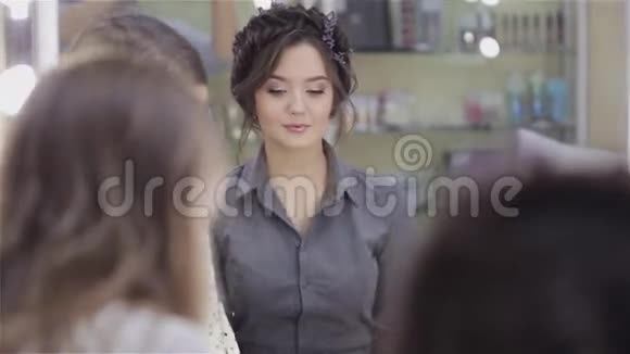 美丽的黑发女孩使用专业化妆师的服务视频的预览图