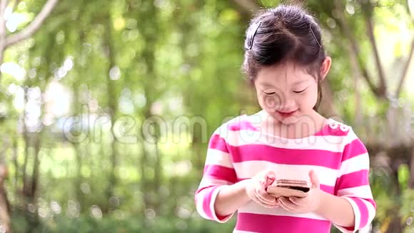 孩子女孩用智能手机或手机说话视频的预览图