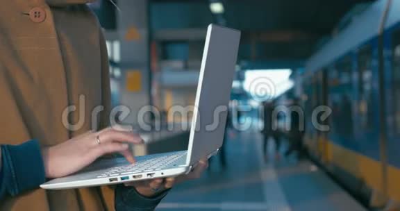 在火车站用笔记本电脑工作的女孩视频的预览图