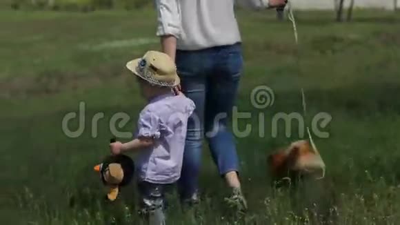 妈妈和儿子在草地上散步视频的预览图