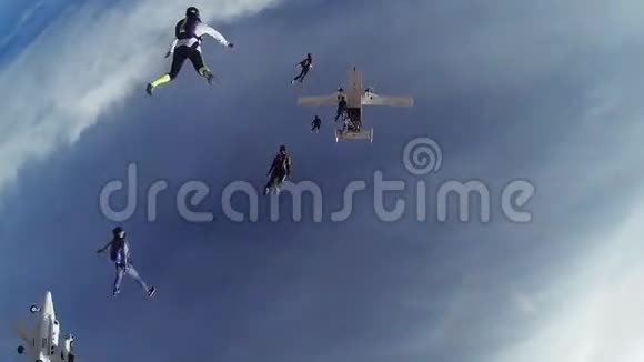 跳伞运动员从降落在蓝天上的飞机上跳下来形成队形极限运动视频的预览图